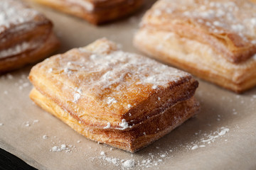 Puff pastry with powdered sugar closeup shot, selective focus