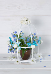 Forget-me-not flowers with birdcage