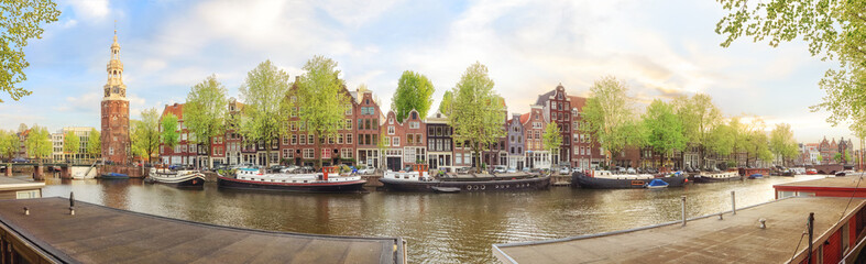 Naklejka premium Canals of Amsterdam. Sunny panorama of old town district