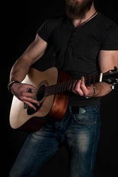 Playing guitar. Acoustic guitar in the hands of the guitarist. Vertical frame