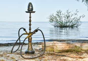  Brass hookah on the nature by the sea river tourism on the background of water