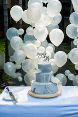 Blue Cake Wedding with Decorate A&B text on top and balloon background. Creative for wedding party