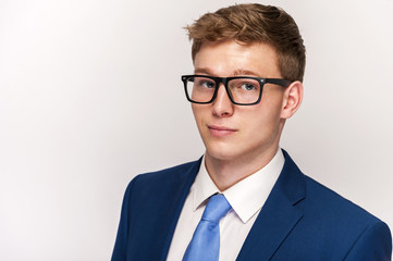 Business Man in blue suit over white background.