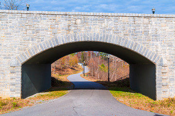 The Piedmont Park Trail and the stone bridge on the Evelyn St NE front view in autumn day, Atlanta, USA.