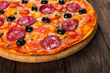 Delicious pizza with salami, mushrooms and olives