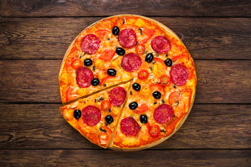 Delicious pizza with salami, mushrooms and olives