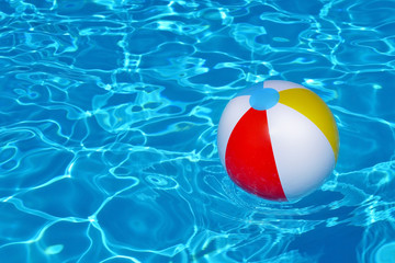 Colorful inflatable ball floating in swimming pool