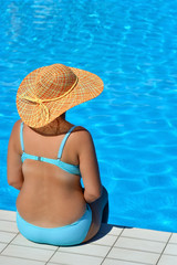 Real female beauty relaxing at swimming pool