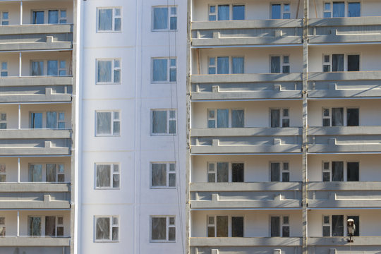 Part of apartment building of bearing-wall construction with balconies at sunny day