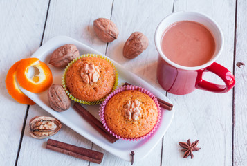 Fototapeta na wymiar Muffins with walnuts and a cup of hot chocolate