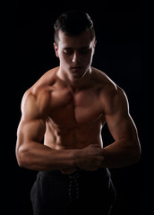 Fototapeta na wymiar Muscular shirtless man showing his muscular arms