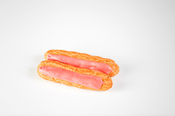 Pink icing Eclairs on white backgound 