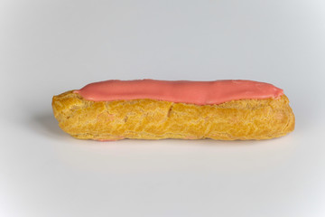 Pink icing Eclairs on white backgound 