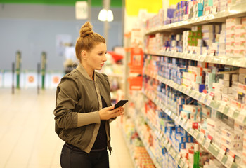 Woman choosing a dairy products at supermarket 