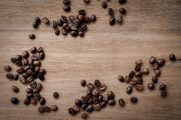 coffee beans isolated on wood background.
