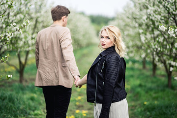 Young couple standing and holding hands