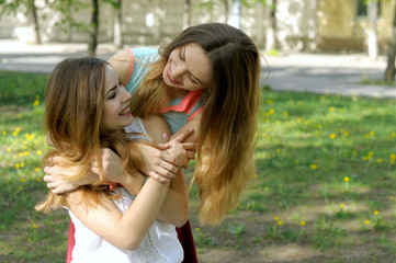 Two sisters embrace enjoying meeting