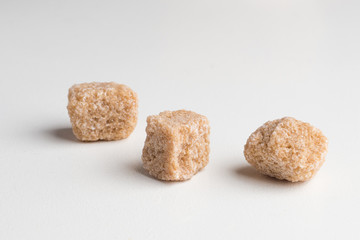 Cane sugar cubes heap close-up macro shot on table