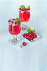 Alcohol cocktail with raspberries and mint
