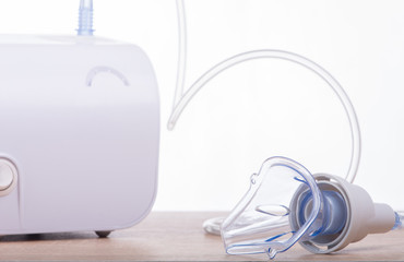 Portable asthma compressor nebulizer machine for children.Isolated on white,focus on mask