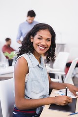 Fototapeta premium Portrait of happy businesswoman working in office