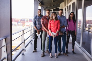 Full length portrait of smiling business people in balcony