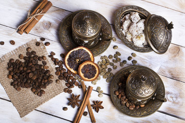 Turkish coffee with delight and traditional copper serving set on wooden