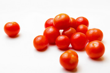Red cherry tomatoes on a white background