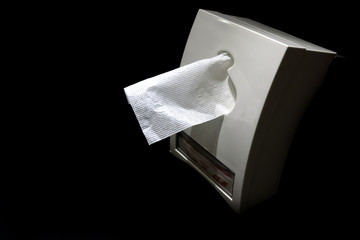 Clean and white napkin in white box with dark background.