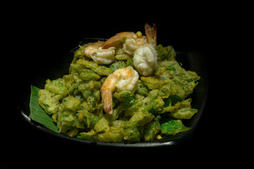 Thai food, crispy fried  vegetable with shrimp in dark background.