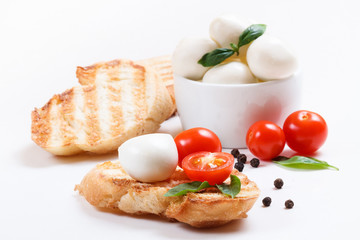Bruschetta with cherry tomatoes, cherry mozzarella, garlic, basil and pepper. Composition.