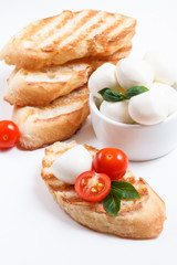 Bruschetta with cherry tomatoes, cherry mozzarella, garlic, basil and pepper. Composition.