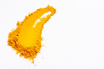 Smear of turmeric. Isolated on white. Top view.