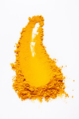 Smear of turmeric. Isolated on white. Top view.