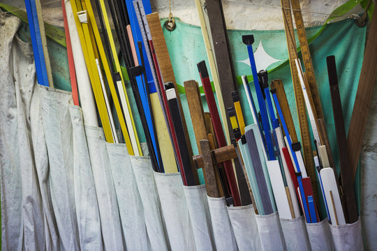 Various length of wood in different colours in a sailmaker's workshop.