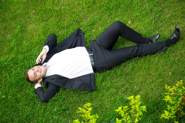 Cheerful young businessman calling by phone