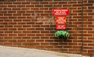 Fire standpipe on a brick wall