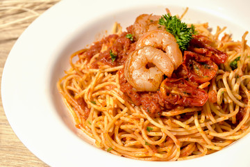 Seafood pasta Spaghetti with Clams, Prawns, Seafood Cocktail in set have salad on wood table