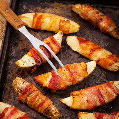 Bacon Wrapped Potatoes Wedges. Selective focus.