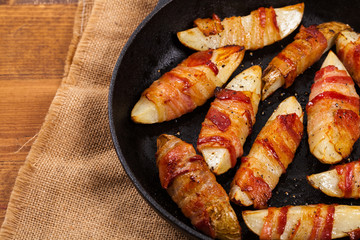 Bacon Wrapped Potatoes Wedges. Selective focus.