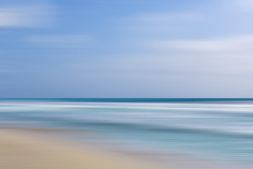 Beach view with motion blur effect. Calm and pastel coloured wallpaper. Copy space.