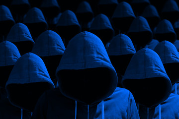 Group of hooded hackers in blue cybersecurity concept