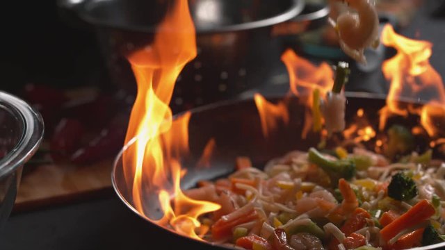 Stir fry into flaming pan in super slow motion, shot on Phantom Flex 