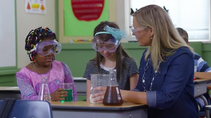 Teacher and students doing science experiment in school classroom - Powered by Adobe