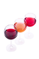 Red, white and rose wine glasses up on white isolated. Top view..