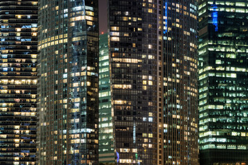 Fototapeta na wymiar Amazing glowing windows of skyscrapers at evening