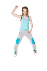 Young, pretty natural looking girl in sport t -shirt and jogging pants having fun dancing. Full body studio shot, pure white background.