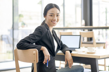 Businesswoman working on desk with laptop computer,Business woman in professional look and happy smiling