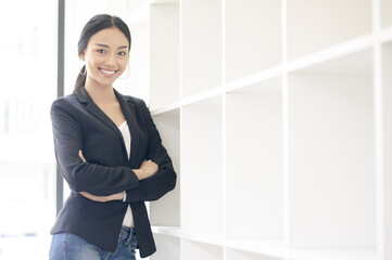 Businesswoman cross one's arm,Professional woman is smiling in black suite.