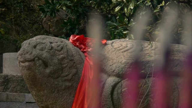 Stone turtle totem with Red ribbon,Burning incense in Incense burner,Wind of smoke.